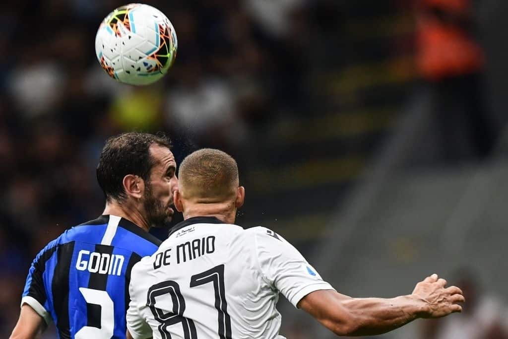Inter Milan's Uruguayan defender Diego Godin (L) and Udinese's French defender Sebastien De Maio go for a header during the Italian Serie A football match Inter Milan vs Udinese on September 14, 2019 at the San Siro stadium in Milan. (Photo by Miguel MEDINA / AFP)        (Photo credit should read MIGUEL MEDINA/AFP via Getty Images)